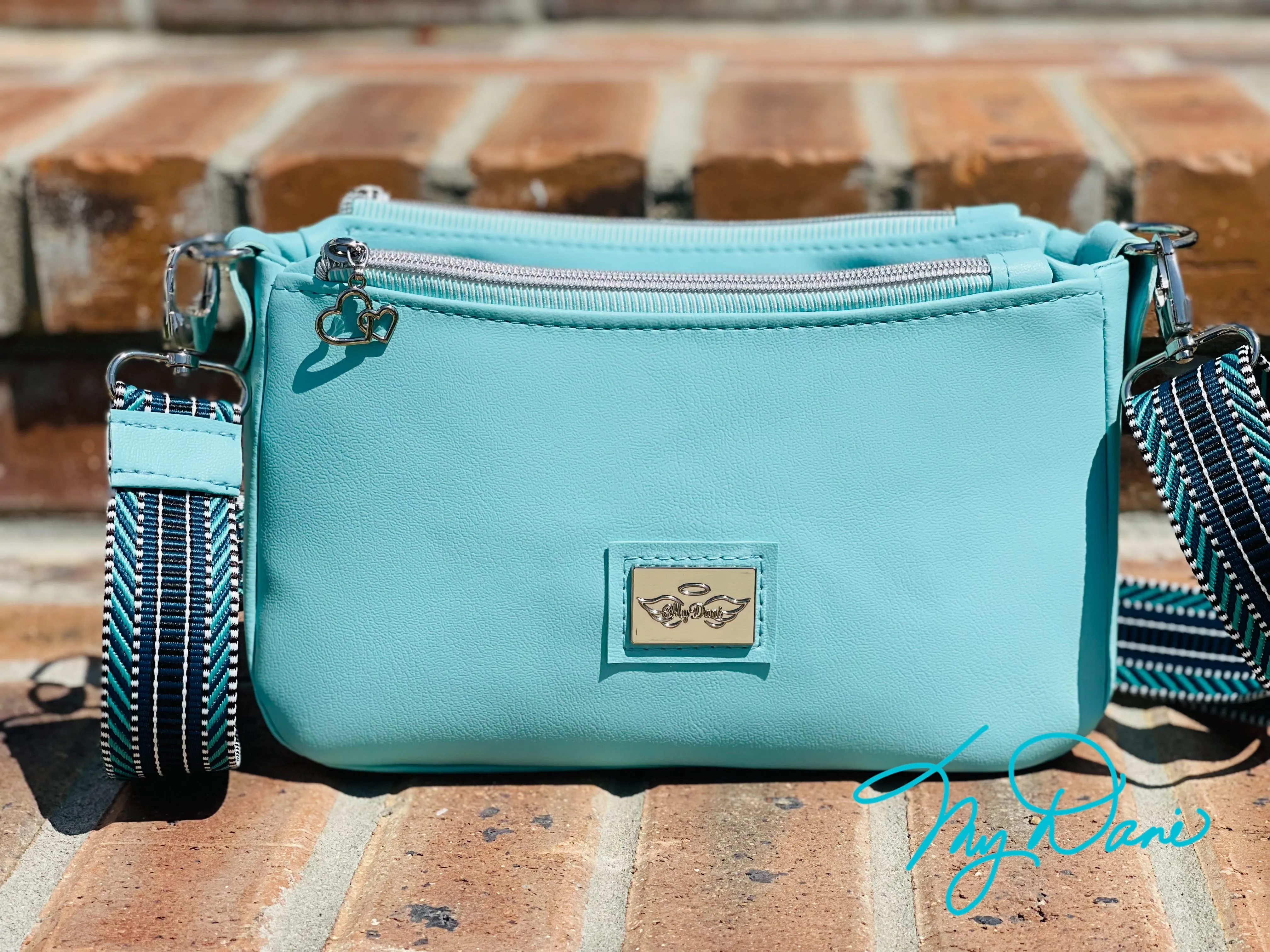 The Aries Crossbody Handbag in Baby Blue Marine Vinyl