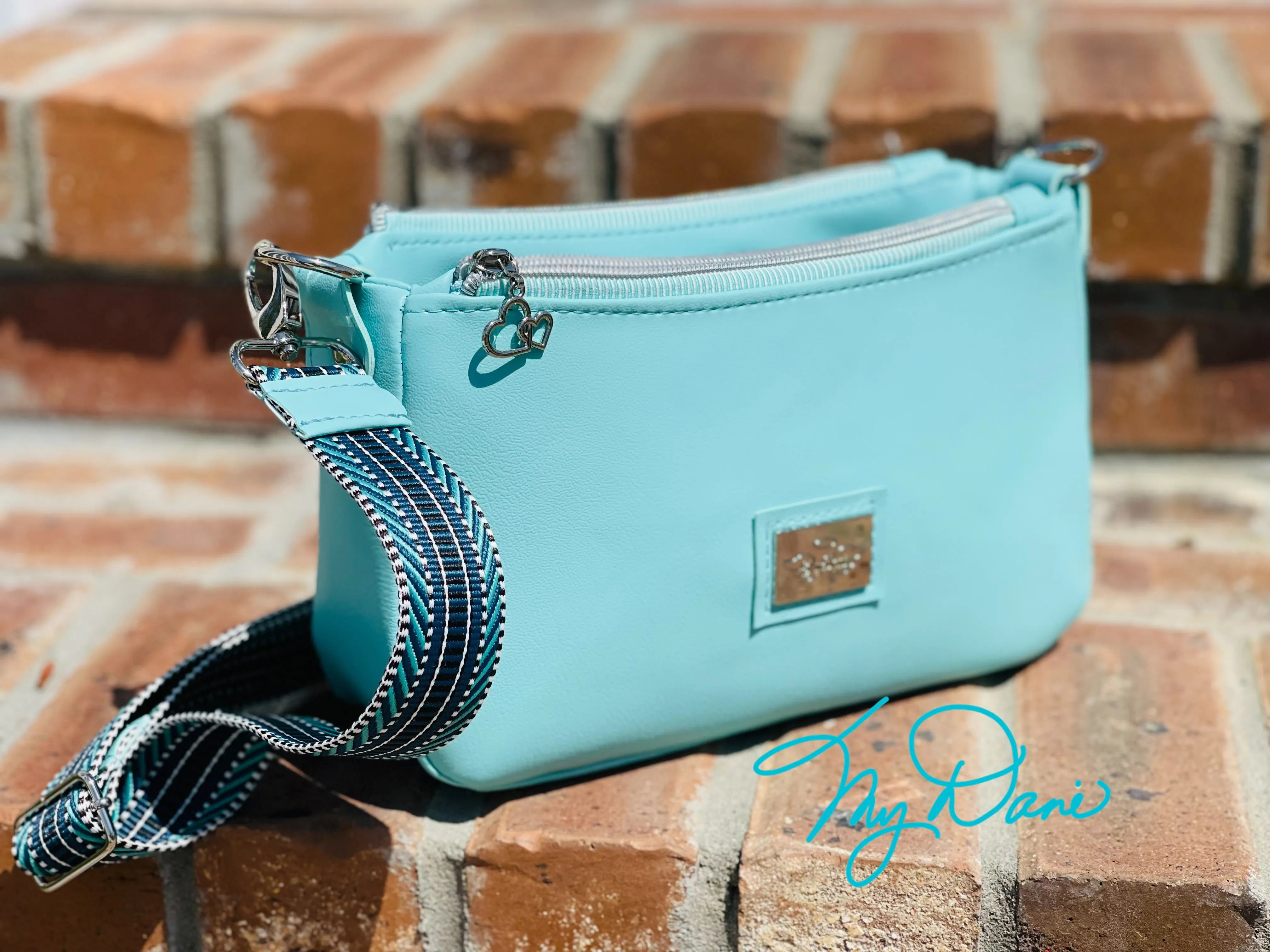 The Aries Crossbody Handbag in Baby Blue Marine Vinyl