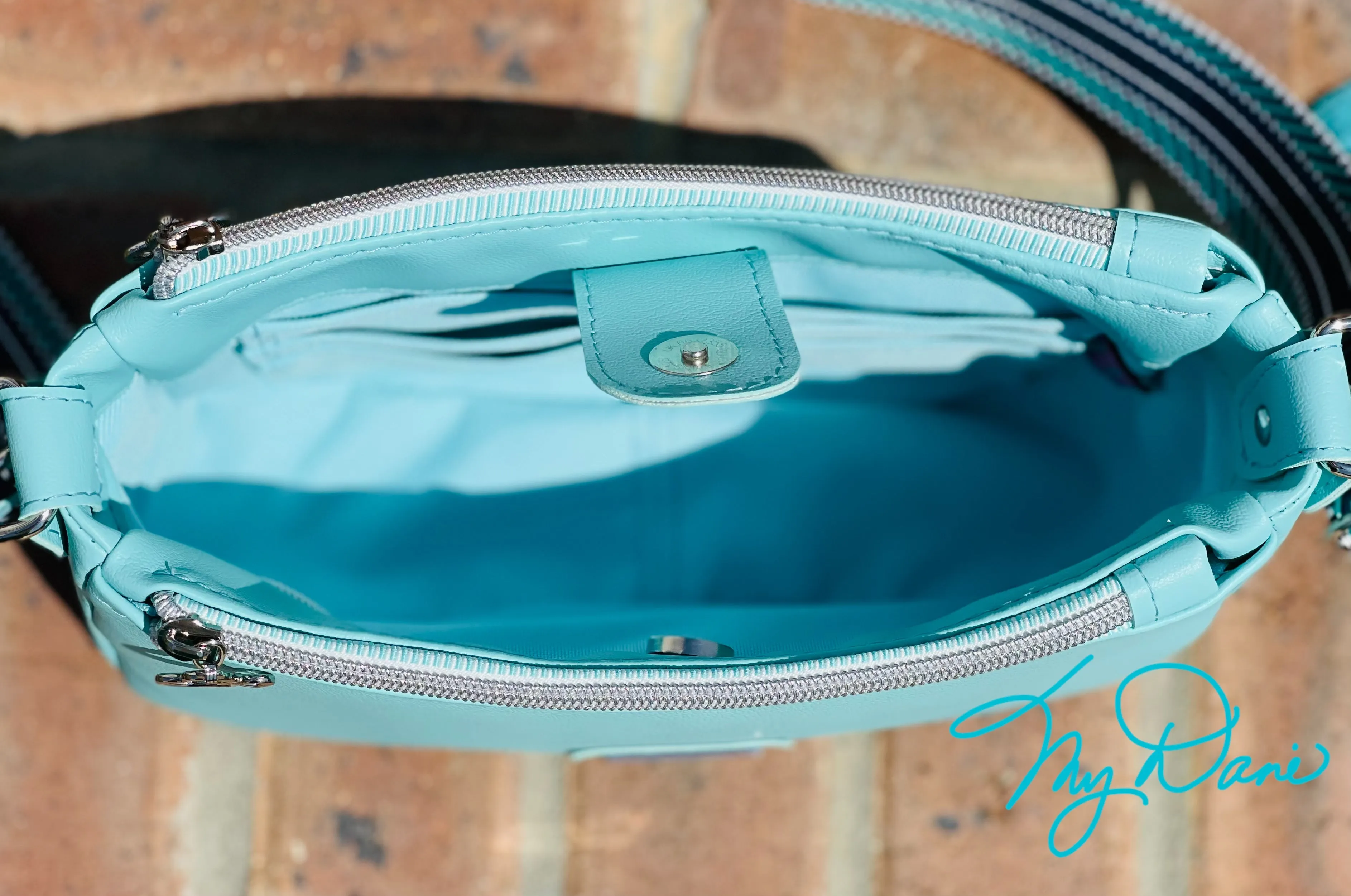 The Aries Crossbody Handbag in Baby Blue Marine Vinyl