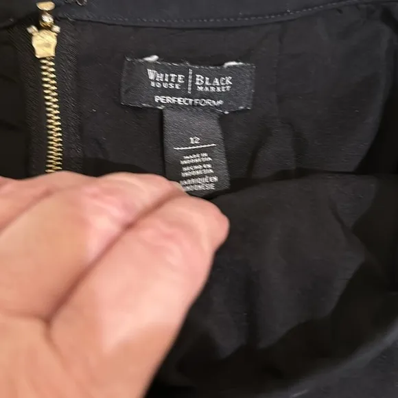 WHBM black zippered skirt. Size 12. Has lines going down for a flattering look.